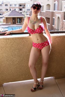 41259684 005 0c0e 262x388 - Busty amateur chick Susy Rocks shows herself shades clad in a polka-dot bikini on the balcony